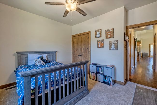 Carpeted bedroom featuring baseboards and a ceiling fan | Image 22