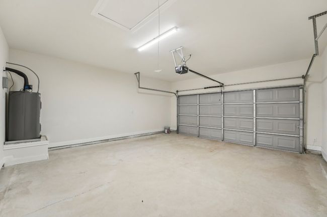 Garage with water heater and a garage door opener | Image 33