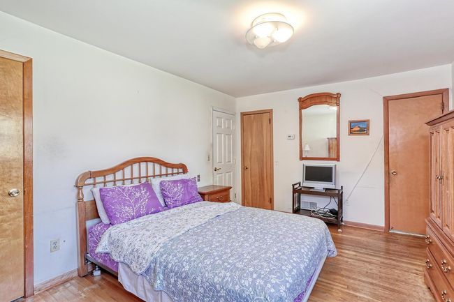 Bedroom with baseboards and light wood finished floors | Image 15