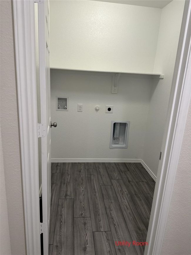 Laundry area featuring hookup for an electric dryer, hookup for a gas dryer, dark wood finished floors, and hookup for a washing machine | Image 5