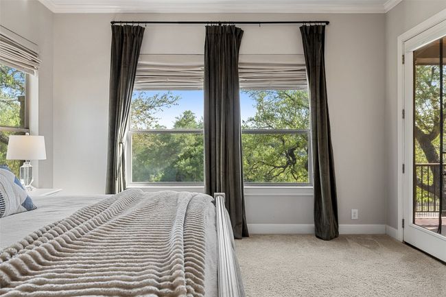Bedroom featuring crown molding, carpet flooring, baseboards, and access to outside | Image 16