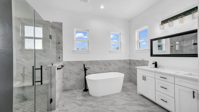 Full bath featuring marble finish floor, recessed lighting, a marble finish shower, a freestanding bath, and vanity | Image 24