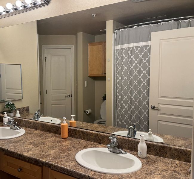 Bathroom featuring vanity and a shower with curtain | Image 11