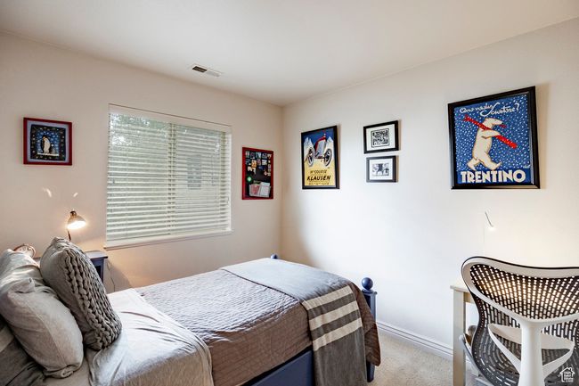 Bedroom featuring arched walkways, vaulted ceiling, and light carpet | Image 20