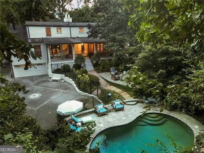 Rear view of house featuring a garage and a patio | Image 2