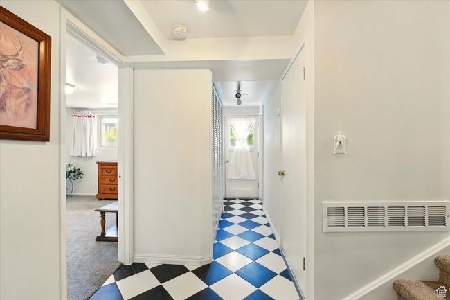 Hall featuring tile patterned floors, baseboards, and stairs | Image 12