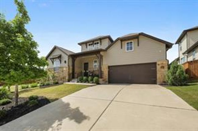View of front of home featuring a garage, concrete driveway, and a front yard | Image 5