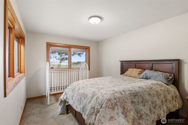Secondary bedroom with views of the lake and built in shelving. | Image 22