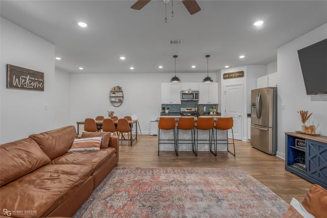 Living area with visible vents, ceiling fan, recessed lighting, and light wood-style floors | Image 6