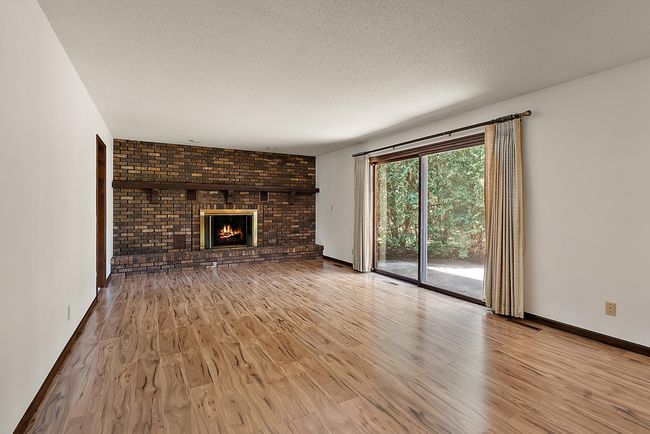 Family Room just off the kitchen with wood burning fireplace. | Image 13