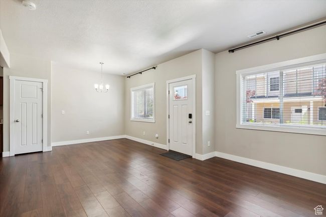 Foyer with a chandelier, baseboards, and dark wood-style floors | Image 8