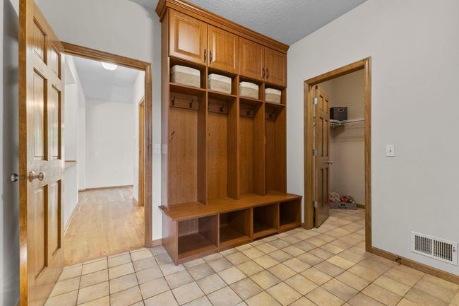 Main Floor mudroom off garage with built ins and closet for storage | Image 25