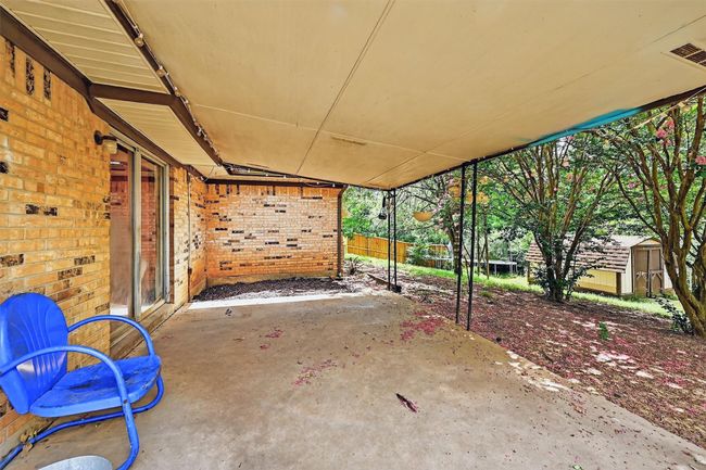 View of patio with a storage shed | Image 25