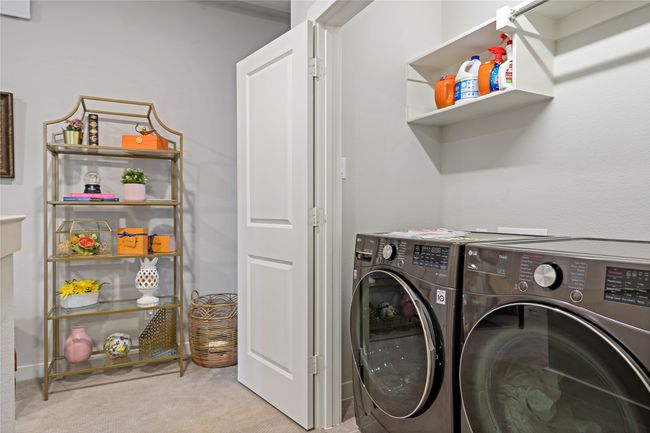 Washroom featuring light colored carpet and washing machine and clothes dryer | Image 20