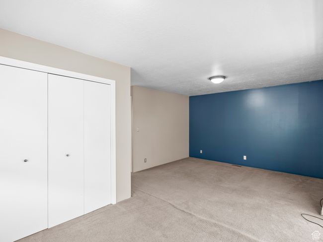 Unfurnished bedroom featuring light carpet and a closet | Image 15
