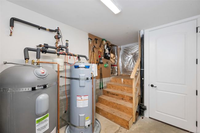 Utility room with strapped water heater | Image 99