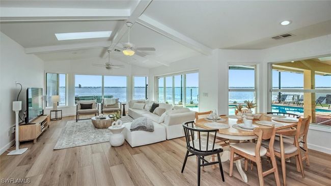 Living Room featuring a water view, plenty of natural light, and a skylight | Image 11