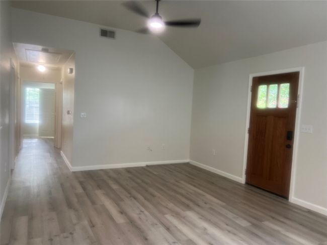 Entrance foyer with ceiling fan, light wood-type flooring, healthy amount of natural light, and lofted ceiling | Image 4