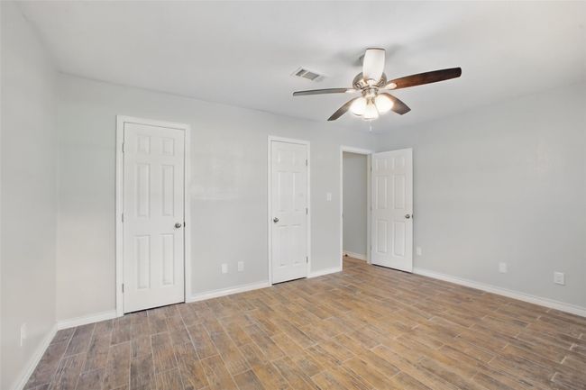The primary suite offers space to unwind, with soothing tones, natural light, and a direct connection to a beautifully updated bathroom. | Image 20