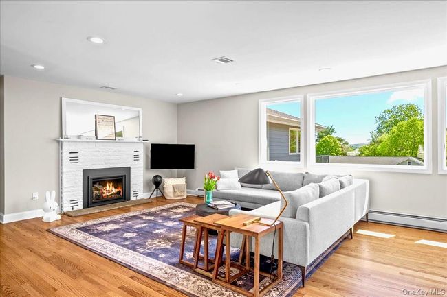 Living area featuring a stone fireplace, recessed lighting, and baseboards | Image 6