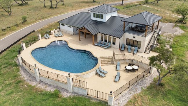 View of pool with an outdoor hangout area, a gazebo, stairway, and a patio area | Image 18