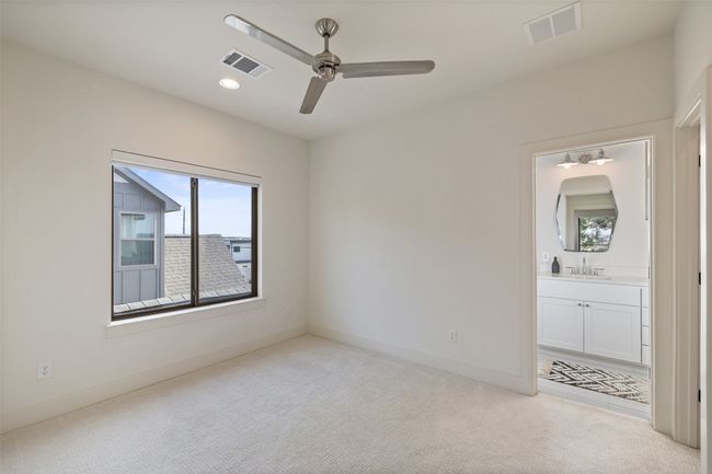 Unfurnished bedroom featuring carpet flooring, baseboards, visible vents, and a sink | Image 27
