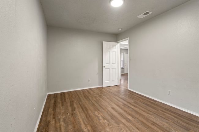 Spare room featuring wood finished floors and baseboards | Image 18