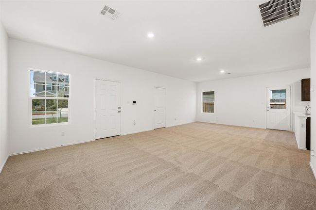 Unfurnished living room featuring light carpet and recessed lighting | Image 10