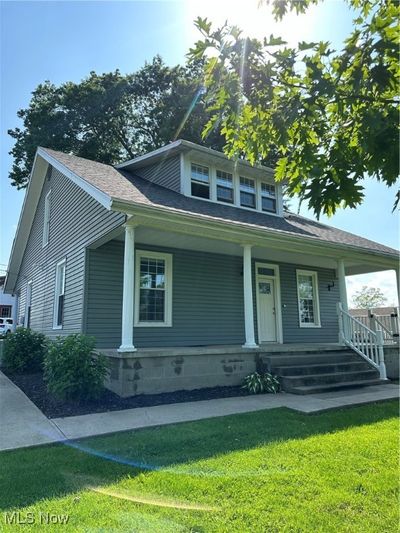 View of front of home with a front lawn and covered porch | Image 2