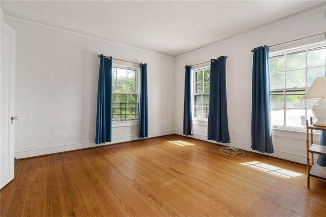 Bedroom with wide baseboards and beautiful hardwood flooring. | Image 19