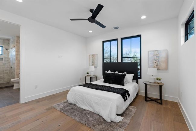 Bedroom featuring multiple windows, recessed lighting, wood finished floors, and baseboards | Image 26