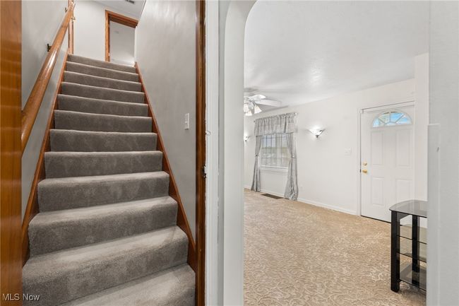 Stairs featuring ceiling fan and carpet | Image 12