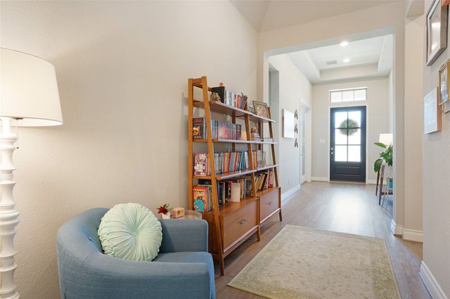 Foyer entrance with wood finished floors and a raised ceiling | Image 10