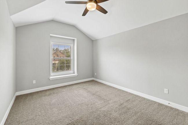 Additional living space featuring lofted ceiling, carpet, a ceiling fan, and baseboards | Image 35