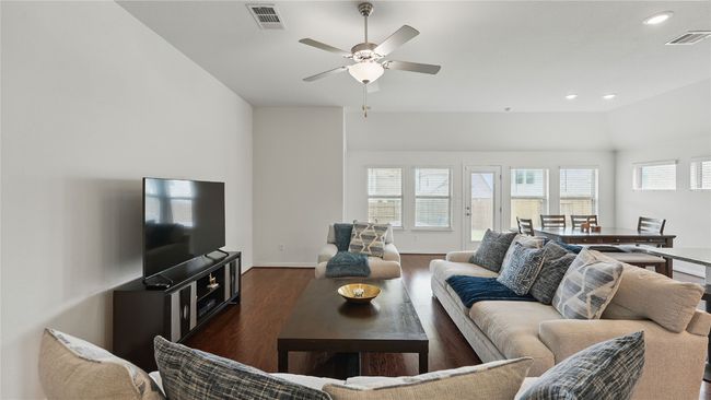 Living area featuring dark wood-style floors, a ceiling fan, recessed lighting, and vaulted ceiling | Image 21