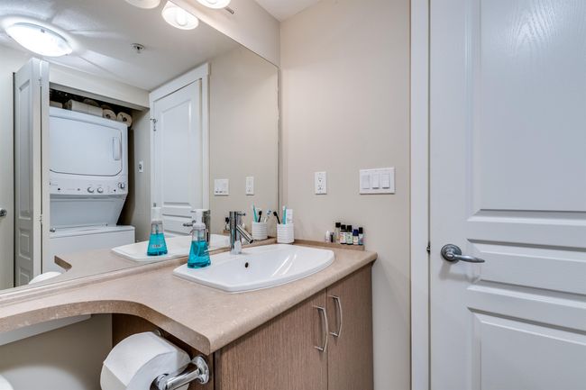 Bathroom featuring stacked washer / drying machine and vanity | Image 15