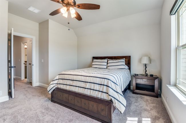 Bedroom with carpet floors, a ceiling fan, and lofted ceiling | Image 22