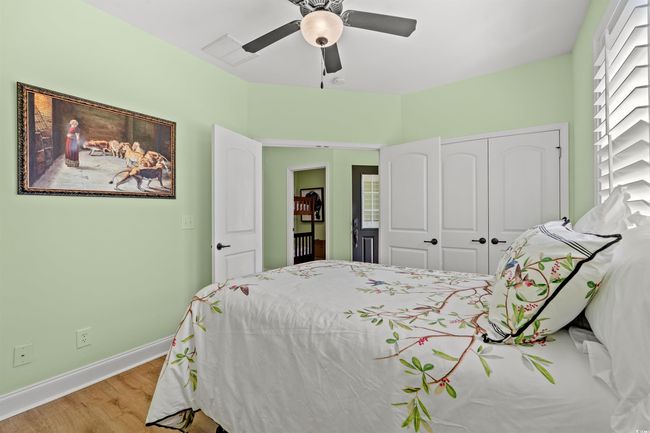 Bedroom with baseboards, visible vents, a closet, ceiling fan, and wood finished floors | Image 8