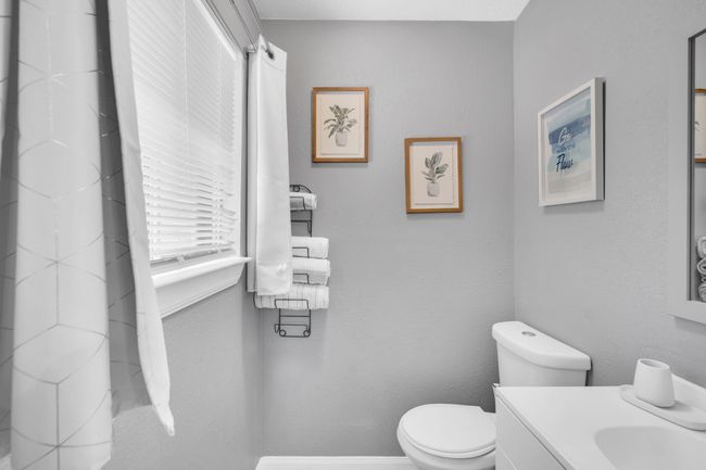 Bathroom featuring baseboards, toilet, and vanity | Image 20