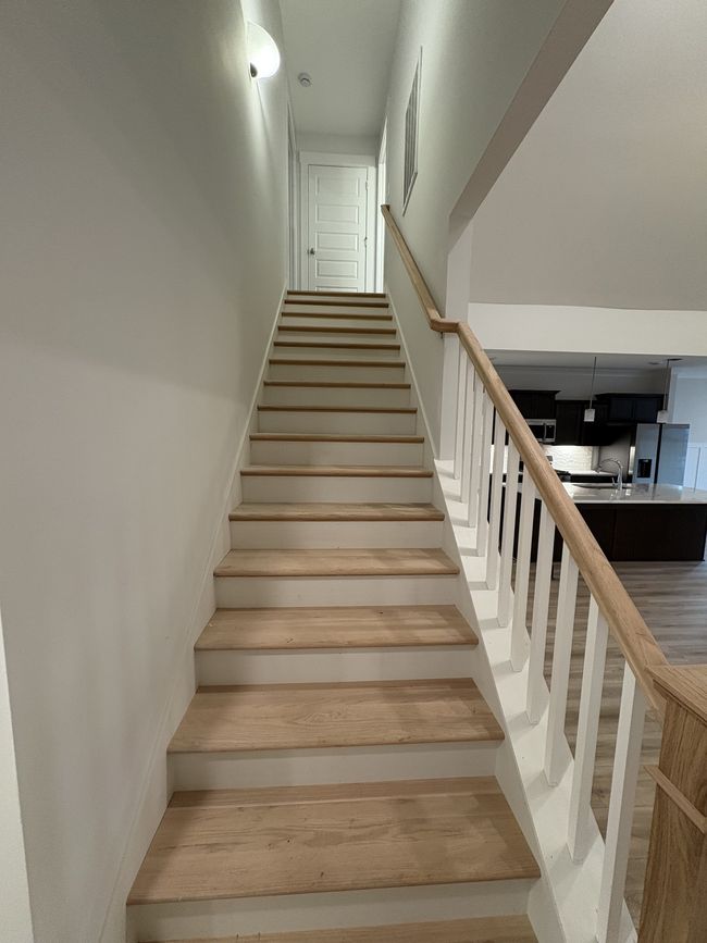 STOCK PHOTO. SELECTIONS WILL VARY IN ACTUAL HOUSE. Oak tread stairs lead upstairs to a huge bonus and full bathroom. | Image 20