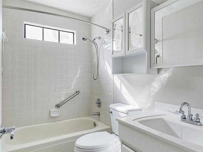 Full bath with a textured ceiling, toilet, shower / tub combination, and vanity | Image 26