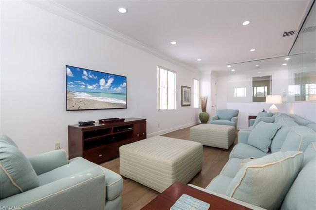 Living room with crown molding, wood finished floors, and recessed lighting | Image 16
