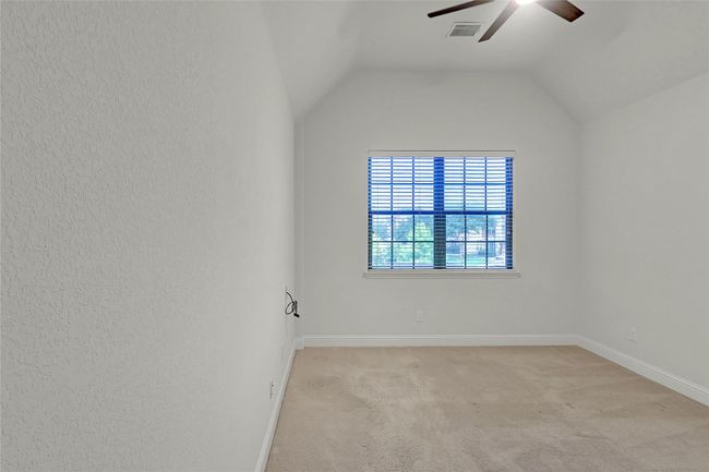 Spare room with a ceiling fan, light colored carpet, and lofted ceiling | Image 33
