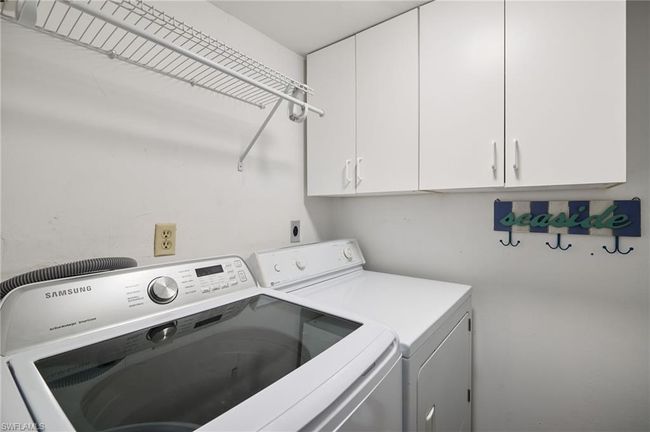 Washroom with cabinets and washer and dryer | Image 18