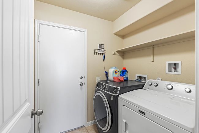 Laundry room featuring independent washer and dryer, laundry area, and light tile patterned floors | Image 15