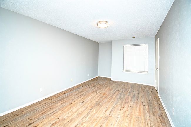 Unfurnished room featuring a textured ceiling and light wood-type flooring | Image 23