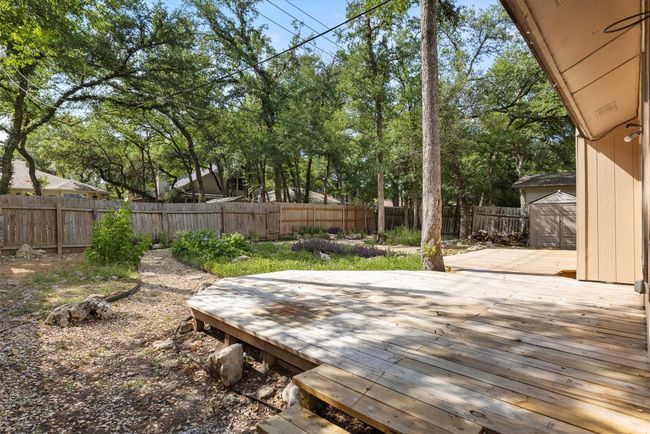 The expansive back deck offers plenty of space for outdoor dining, relaxation, and enjoying the natural surroundings | Image 20