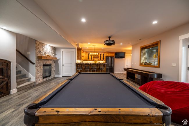 Game room with billiards, bar area, dark wood-style floors, recessed lighting, and a fireplace | Image 55