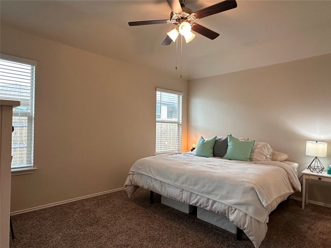 Carpeted bedroom with baseboards and a ceiling fan | Image 29