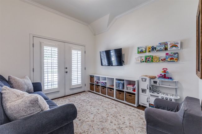 Study currently being used as the children's playroom. French door open to front porch. | Image 7